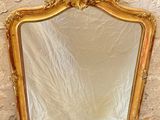 a mirror that is sitting on the floor in front of a wall