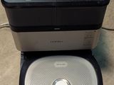 a robot that is sitting on the floor next to a toaster