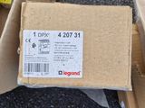 a cardboard box sitting on the ground next to a cardboard box with a sticker on it