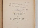 an old book with writing on it sitting on a table