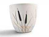a white vase with a black cattails on it