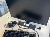 an image of a computer monitor and keyboard on a desk