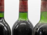 three bottles of wine sitting on top of a table next to each other