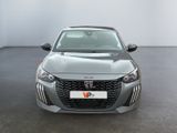 the front view of a grey car in a room with a white wall