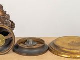 a statue of a man sitting on top of a clock