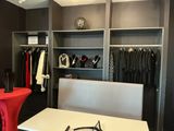 a white table with a red chair in front of a closet