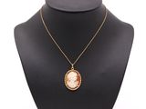 un collier sur lequel est représentée une femme, porté par un mannequin