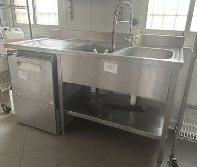 a kitchen with a sink and a dishwasher in it