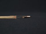 a close up of a pen on a black surface with a black background
