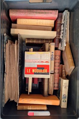 a box full of books with a sign in it