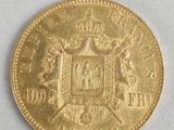 a close up of a gold coin on a white surface