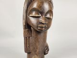 an image of a wooden sculpture of a woman with her eyes closed