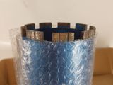 a blue vase that is wrapped in plastic and sitting on a table