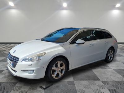 the white car is parked in the garage on the checkered floor