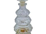 an image of a clear glass bottle with a glass stopper on top