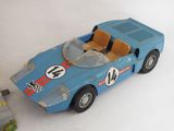 a toy car that is sitting on a white surface