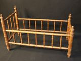 a small bed with a wooden frame on a black background