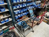 a cart that has a laptop on it in a store