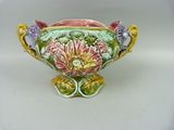 a vase with a flower design on it on a white surface