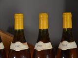 three bottles of wine are lined up on a table