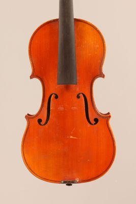 an old violin with a bow hanging from it ' s back