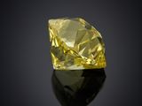 a yellow diamond on a black surface