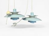 two blue and yellow pendant lights hanging from a white ceiling