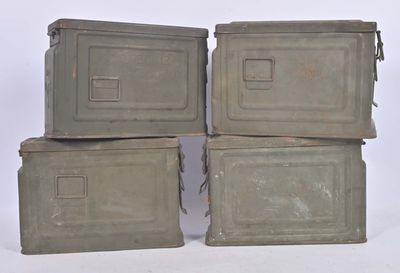 three old metal boxes stacked on top of each other on a white surface