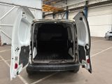 a white van with its doors open in a parking lot