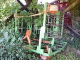 a green machine that is sitting in the middle of a field