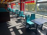tables and chairs in a restaurant with a view of a river