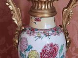 a vase that is sitting on a table in front of a wall