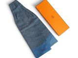 tie and box on a white surface with orange box in the background