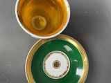 an overhead view of a cup and saucer on a table