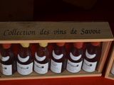 several bottles of wine are in a wooden box on a red surface
