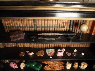 a book shelf with a lot of books and figurines on it