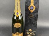 a bottle of pommery champagne next to a box