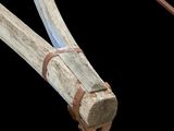 a close up of a wooden object on a black background