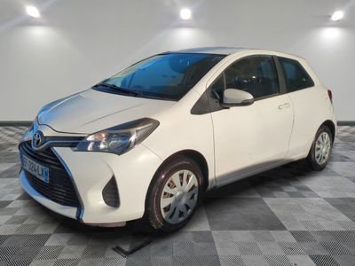 the toyota yaris is parked in a clean room with checkered flooring