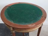 a small table with a green top on a black floor