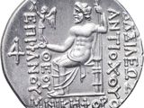 a close up of a silver coin with a statue on it
