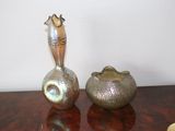 two vases that are sitting on a table next to each other