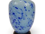 a blue vase with a black base on a white background