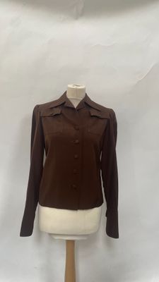 a woman ' s brown jacket on a mannequin dummy