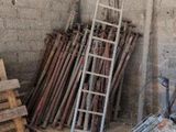 a ladder leaning against a wall next to a pile of wood