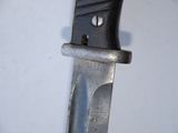 a close up of a knife on a white surface