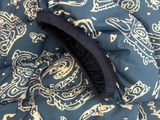 a close up of a blue and white paisley print fabric