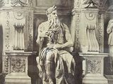 an old photo of a statue of a man sitting on a throne