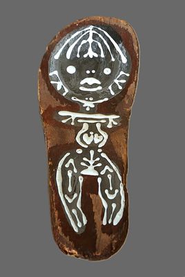 a picture of a clay figurine of a person on a gray background