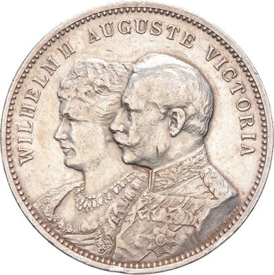 une vieille pièce d'argent sur laquelle figurent les portraits d'un homme et d'une femme